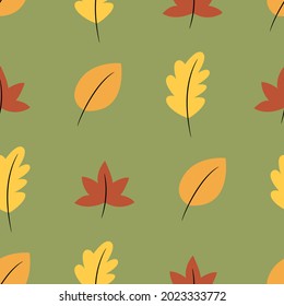 Autumn leaves seamless pattern. Green background, symmetrical, multicolored elements.