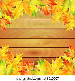 Autumn maple leaves on a background of wooden planks