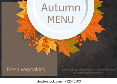 Autumn menu. Plate with yellow leaves Rowan. On a wooden table.