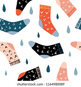 Autumn mood seamless pattern with cute colorful socks and rain drops. Fall season clothing. Flat doodle Hand drawn accessories. Cute cozy colorful background for seasonal textile, paper