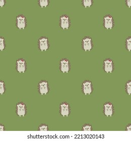 autumn pattern with hedgehogs on a green background.