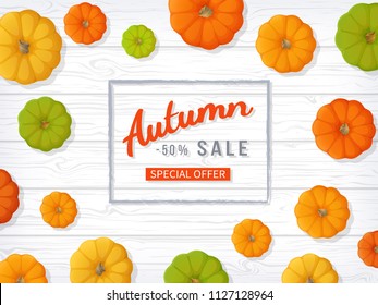 Autumn sale background. Horizontal banner flyer in a rectangular frame with colored pumpkins on a white wooden table. Special seasonal offer, discount.  Vector illustration. Top view
