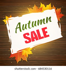 Autumn sale background with maple leaves and wood planks.