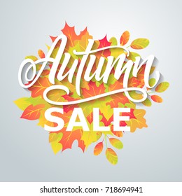 Autumn sale. Bright abstract background with leaves. Modern handmade vector lettering.