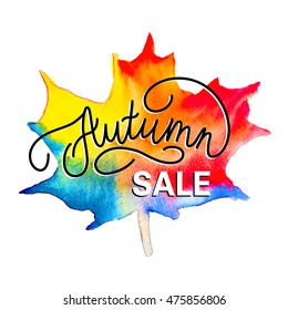Autumn sale, hand-drawing of the inscription on the background of watercolor maple leaf.