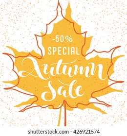 Autumn sale - handwritten lettering on shape of fall maple leaf; vector illustration; poster or label for shop or market; orange silhouette with red contour for promotion