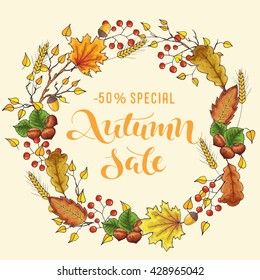 Autumn sale - handwritten lettering, autumn wreath with branch, maple and oak leaves, nuts, berries, wheat and acorns; hand drawn vector illustration; poster or label for shop or market for promotion