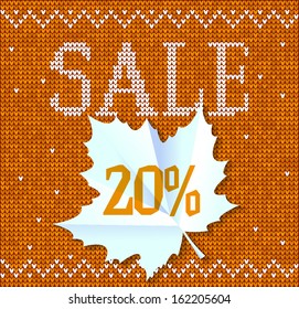 Autumn sale - paper leaf on sweater background