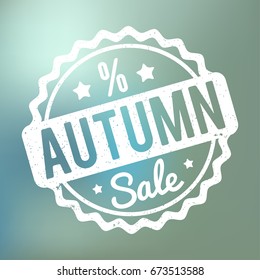 Autumn Sale rubber stamp white on a blue bokeh background.