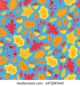 Autumn seamless pattern with berries, acorn, maple and oak leaves on blue background. Perfect for seasonal greeting cards, wallpaper