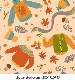 Autumn seamless pattern with clothes and leaves. Vector graphics.