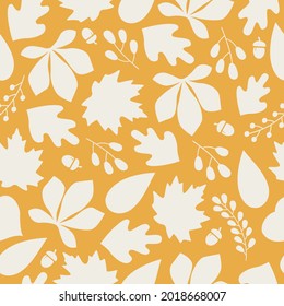 Autumn seamless pattern with colorful silhouette acorns, leaves and berries on orange background. Modern seasonal pattern. Vector flat design	