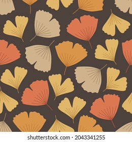 Autumn seamless pattern with cute ginkgo biloba leaves. Vector illustration on brown background. Fall ornament. Foliage print for fabric, package, wrapping, wall art. Red, orange, yellow, beige colors