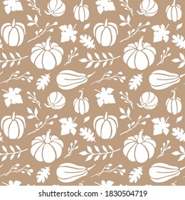 Autumn seamless pattern with gold background and white pumpkins, leaves and branches