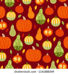 Autumn seamless pattern with leaves and pumpkins on dark red background. Perfect for seasonal and Thanksgiving Day greeting cards 