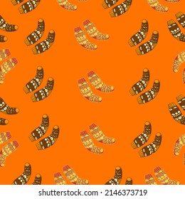 Autumn seamless pattern on orange background with cozy socks. Texture for scrapbooking, wrapping paper, invitations.Vector illustration.