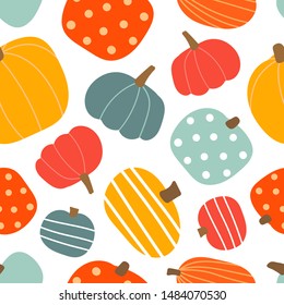 Autumn seamless pattern with orange, blue and yellow pumpkins. Vector background.  Perfect for wrapping paper, wallpaper, background, seasonal fabric print. 