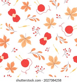 Autumn seamless pattern of orange leaves and yarn