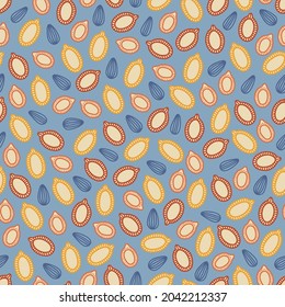 Autumn seamless pattern with pumpkin seeds on blue background. Perfect for wallpaper, wrapping paper, fabric, seasonal holidays. Hand drawn vector illustration