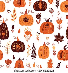 Autumn seamless pattern with pumpkins and floral elements.