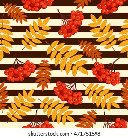 Autumn seamless pattern with rowan leaves and berries on striped background.