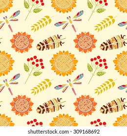 Autumn seamless pattern. Thanksgiving Day repeatable background. Feathers, dragonflies, sunflowers, spikes, branches with rowan berries and leaves