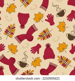 Autumn seamless pattern. Vector fall pattern. Gloves, hat, scarf, leaves on peach-beige background