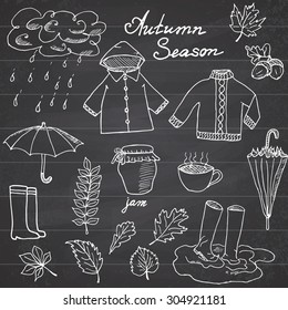 Autumn season set doodles elements. Hand drawn set with umbrella cup of hot tea, rain, rubber boots, clothes and leaves collection. Drawing doodle collection, on chalkboard background.