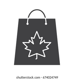 Autumn shopping glyph icon. Silhouette symbol. Shopping bag with maple leaf. Negative space. Vector isolated illustration