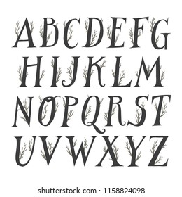 Autumn vector alphabet. Uppercase serif letters decorated with tree branches.