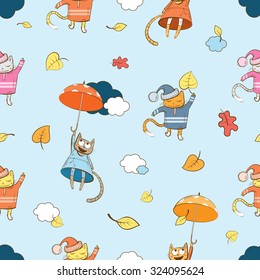 Autumn vector seamless pattern with cartoon cats, umbrellas and leaves on a blue background.