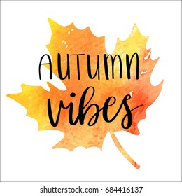 Autumn vibes - hand lettering phrase on orange watercolor maple leaf background