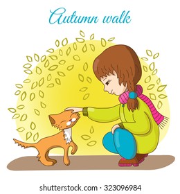 Autumn walk. Girl in trousers and jacket stroking ginger kitten.