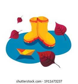 Autumn. Yellow boots on puddle