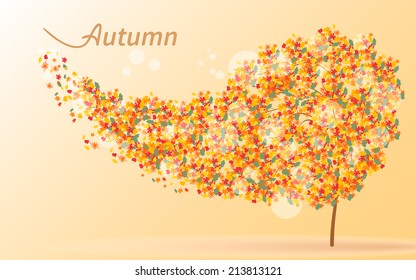 Autumnal background. Wind rips the yellow leaves from the tree