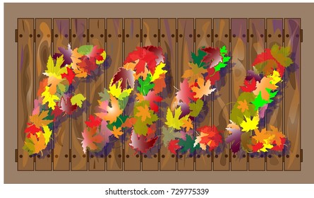 autumnal composition in the form of a word Fall, composed of autumn colorful leaves on a fence