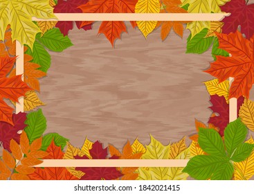 Autumnal forest background frame on wooden table surface