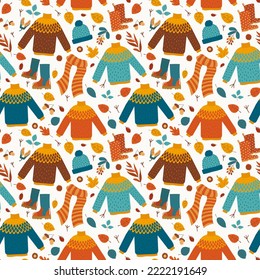 Autumnal seamless pattern with colorful clothes and leaves in flat style