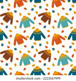 Autumnal seamless pattern with colorful sweater and leaves in flat style