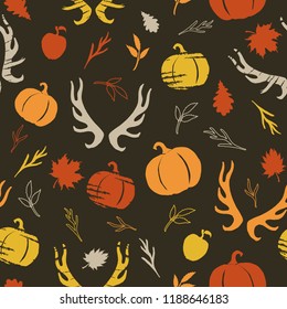 Autumnal seamless pattern with pumpkins, horns and branches