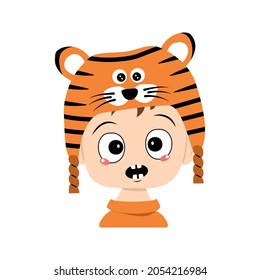 Avatar of boy with emotions panic, surprised face, shocked eyes in tiger hat. Cute kid with scared expression in carnival costume for New Year, Christmas and holiday. Head of adorable child