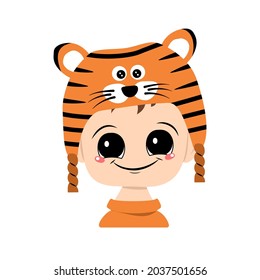 Avatar of a child with big eyes and a wide smile in a tiger hat. Cute kid with a joyful face in a festive costume for new year and Christmas. Head of adorable baby with happy emotions