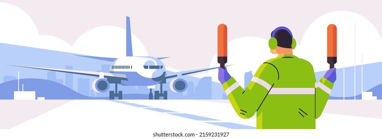 aviation marshaller signaling near aircraft air traffic controller airline worker in signal vest professional airport staff