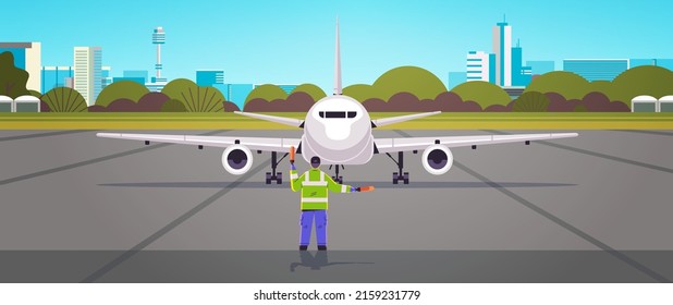 aviation marshaller supervisor in uniform signaling near aircraft air traffic controller airline worker in signal vest professional airport staff