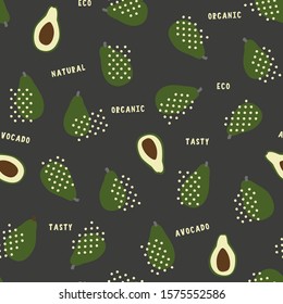 Avocado dark seamless pattern with whole and half fruit vector graphic on black background with organic, tasty, eco, natural text to print on fabric, farmers market wrapping.