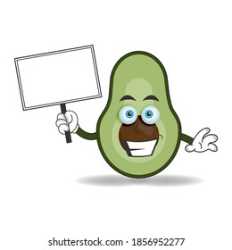 Avocado mascot character holding a white blackboard. vector illustration