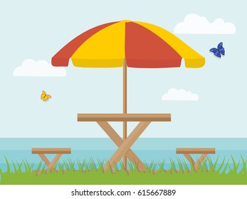 Awning and picnic chairs in nature on the background of the sea