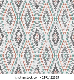 Aztec stylized print template for fabric and paper. Seamless pattern with ethnic ornament and grunge effect. Tribal style background with distressed texture. Summer fashion, boho.