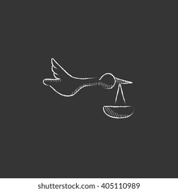 Baby basket with stork. Drawn in chalk icon.