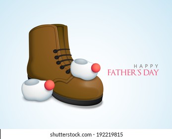 Baby booties with father leather shoe on blue background, concept for Happy Father's Day celebrations. 